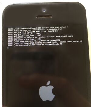 An iPhone 5 with water damage displays the FindFlashMediaAndKeepout error message.