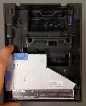 With the printer upside down remove the interface card by pressing the blue spring loaded button and pulling up.